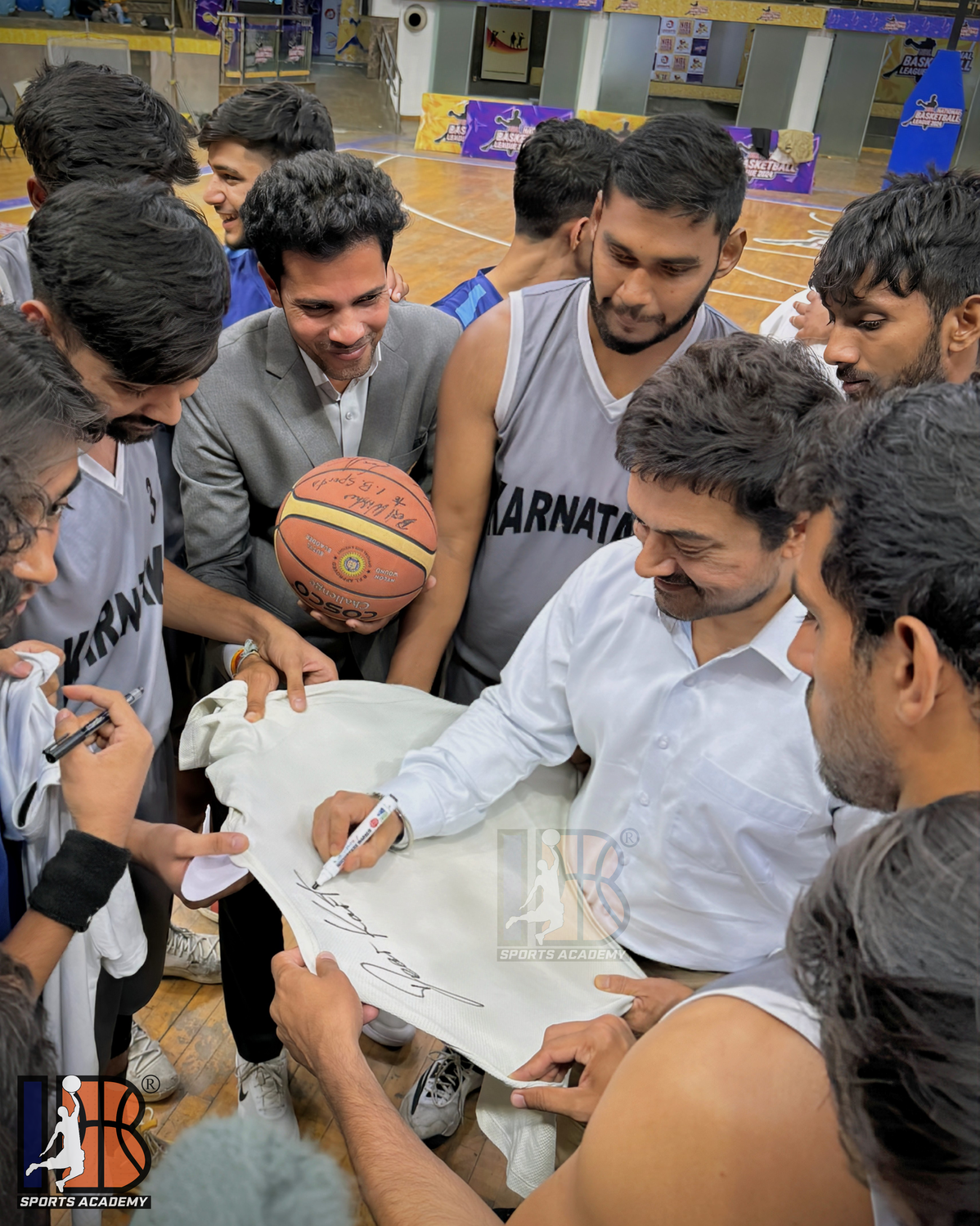 Aamir Khan signing shirt for IB Sports Academy student athlete